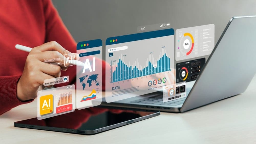 A user operates a laptop alongside a tablet, highlighting the features of user activity monitoring software.